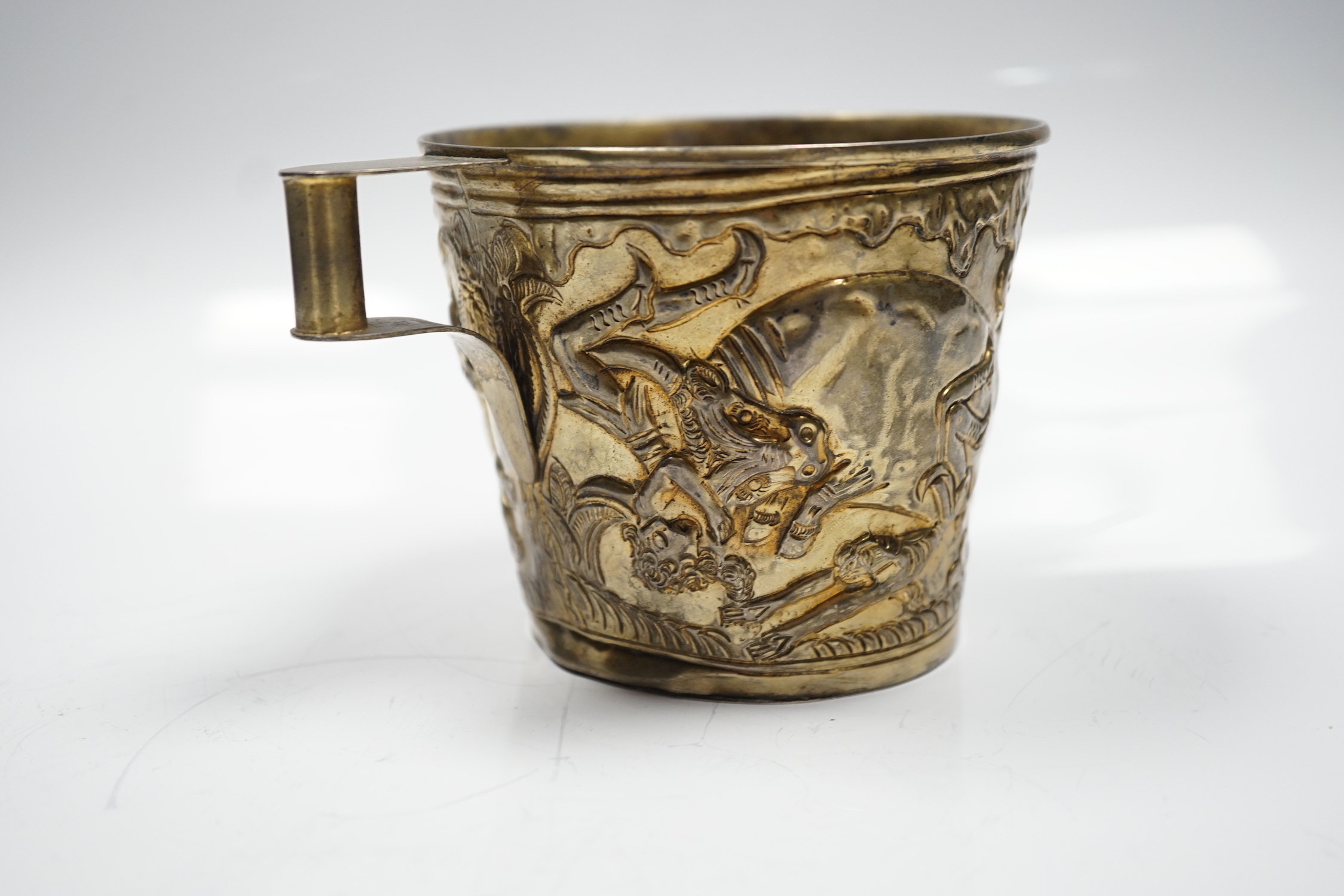 A Greek Lalaounis 900 standard gilt white metal, cup, embossed with continuous raging bull scene, height 90mm, 6.5oz.